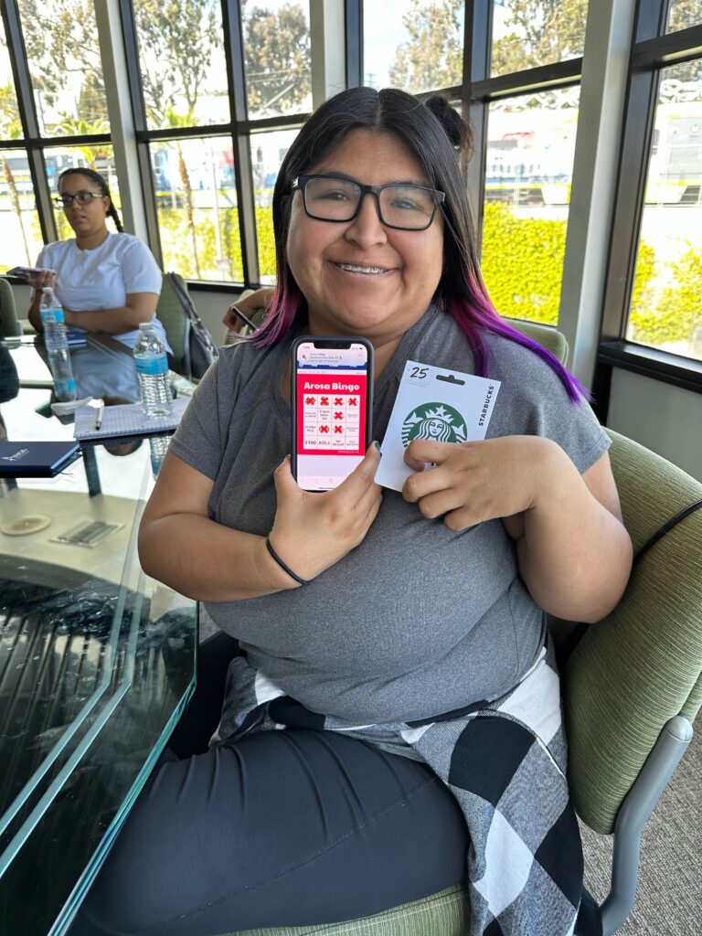 Winner of the Arosa BINGO competition with her prize. - Los Angeles